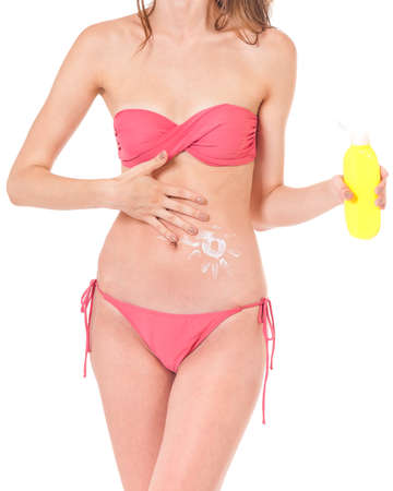 Woman with sun tan lotion in form of the sun isolated on white backgroundの写真素材