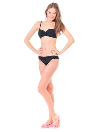 Sexy young woman posing in a black bikini, isolated on white backgroundの写真素材
