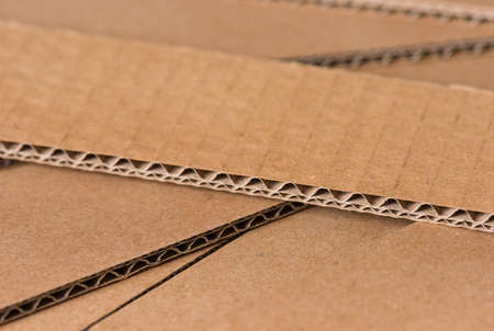 Corrugated cardboard useful as a box. Textured recycled packing cardboard with natural fiber parts.の写真素材