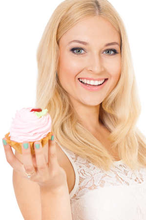 Closeup of smiling woman eating sweet cake on white backgroundの写真素材