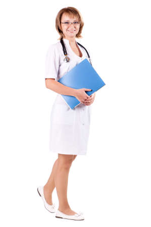 Full body portrait of a beautiful young doctor with file folder and stethoscope in hospitalの写真素材