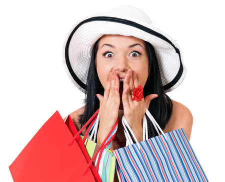 Portrait of young shopaholic woman with many shopping bags, isolated on white backgroundの写真素材
