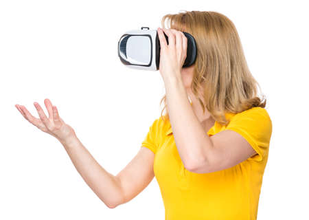 Happy woman wearing virtual reality goggles watching movies or playing video games, isolated on white background. Smiling female looking in VR glasses and gesturing with hands.の写真素材