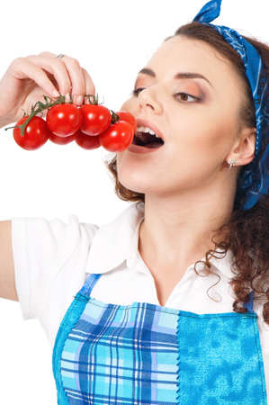 Portrait of beautiful woman holding a fresh tomatos, isolated on white backgroundの写真素材