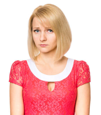 Portrait of woman with beautiful face, isolated on white background. Young cute girl showing different emotions - sadness, sad and depressed. Female wearing a pink dress.の写真素材