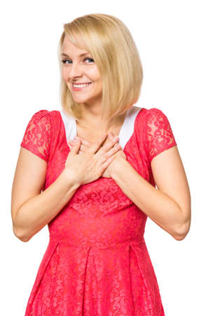 Portrait of woman with beautiful face, isolated on white background. Young cute girl showing different emotions - smiling to you shyly. Female wearing a pink dress.の写真素材