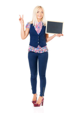 Full length portrait of young business woman with small blackboard posing on white backgroundの写真素材