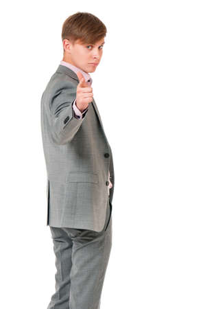 Young handsome man in gray suit isolated on white background. Portrait of a confident businessman looking and pointing at camera choosing you.の写真素材