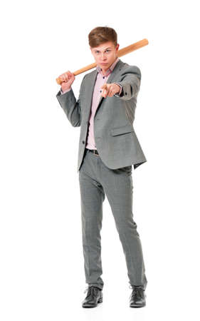 Anger man in suit with wooden baseball bat. Guy standing and pointing at camera choosing you - full length portrait, isolated on white background.の写真素材