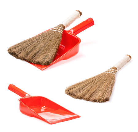 Set of plastic red dustpan with new broom, isolated on white backgroundの写真素材