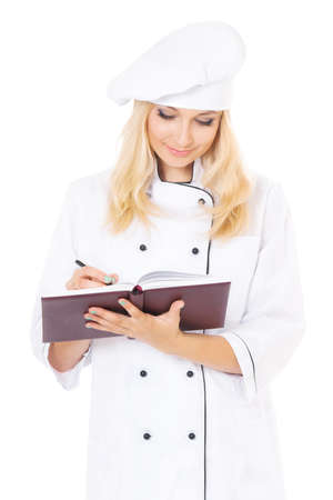 Woman in chef hat with cookbook, isolated on white backgroundの写真素材