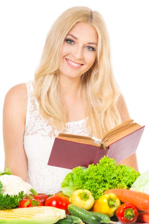 Beautiful woman with recipe book and wooden spoon, isolated on white backgroundの写真素材