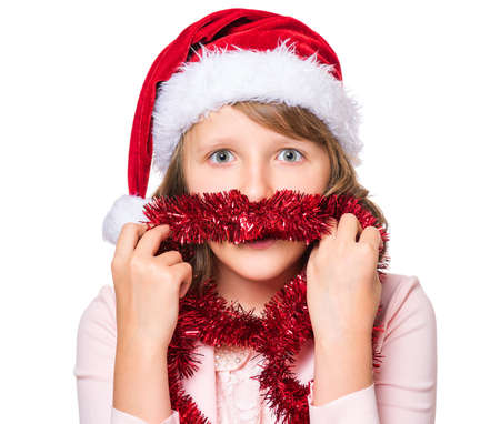 Portrait of smiling little girl with Santa Claus hat. Holiday Christmas concept - happy cute child isolated on white background.の写真素材