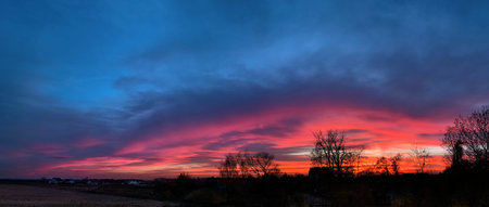 Beautiful colorful autumn panorama of sunset in countryside with wonderful light.