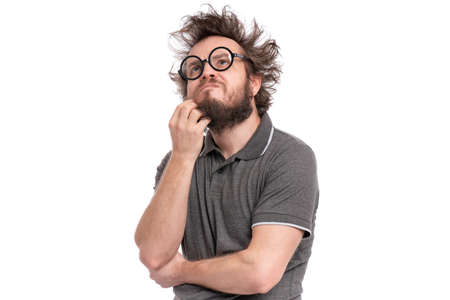 Crazy thoughtful bearded Man with funny Haircut in eye Glasses - ponder and dreaming. Casual thinking guy, isolated on white background. Emotions, and signs concept.の写真素材
