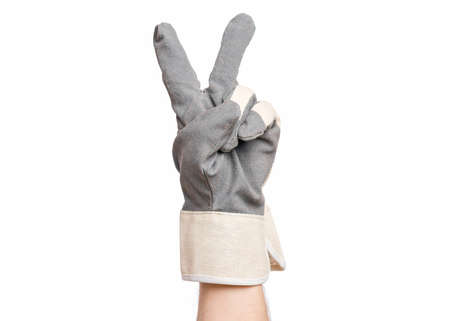 Worker showing gesture - two fingers, victory sign. Male hand wearing working glove with, isolated on white background.の写真素材