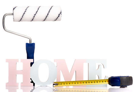 HOME word concept - Text Banner with Tape Measure tool and Paint Roller Brush, isolated on white background.の写真素材