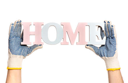 Close up view of Worker Man Hands with HOME word concept. Male Hands wearing Working cotton Glove with Text Banner. Human hands holding Home, isolated on white background.の写真素材