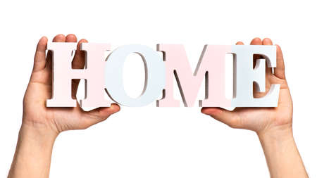 Close up view of Worker Man Hands with HOME word concept. Male Hands with Text Banner. Human Hands holding Home word, isolated on white background.の写真素材