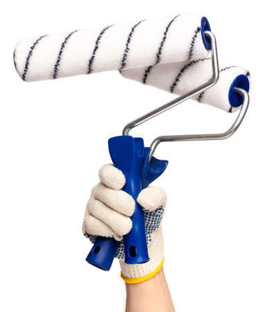 Close up view of Worker Man Hand with Paint Roller Brush. Male Hand wearing Working cotton Glove with Tools. Human hand holding new Roller, isolated on white background.の写真素材