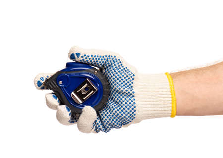 Close up view of Worker Man Hand with Tape Measure. Male Hand wearing Working cotton Glove with Tape-measure. Human hand holding tape measure, isolated on white background.の写真素材