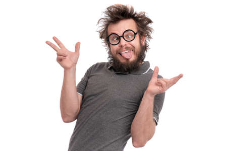 Crazy bearded Man with funny Haircut in eye Glasses making grimace - funny face. Casual Silly guy, isolated on white background. Emotions, and signs concept.の写真素材