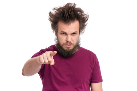 Crazy bearded Man with funny Haircut points his finger at you. Serious Guy looking at camera and pointing to the front, isolated on white background. Emotions and signs concept.の写真素材