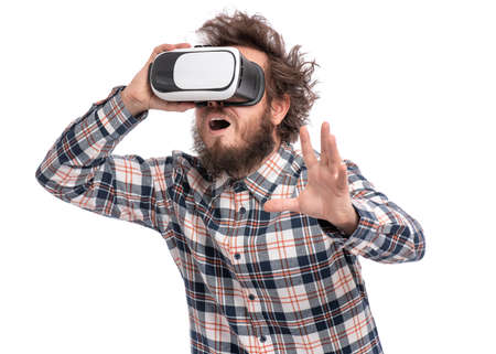 Crazy bearded Man in plaid shirt with funny Haircut wearing virtual reality helmet, isolated on white background. Portrait of funny happy man using VR goggles.の写真素材