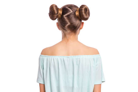Rear view of teen girl with funny hairstyle, isolated on white background. Portrait of caucasian child - back view.の写真素材