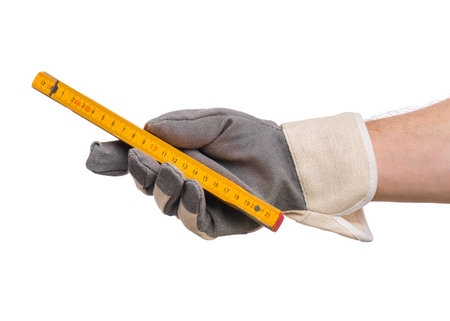 Male Hand wearing Working Glove with yellow wooden meter. Human Hand holding tool, Isolated on White...