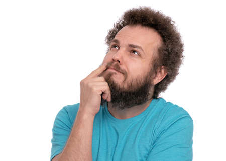 Crazy thoughtful bearded Man with funny Curly Hair - ponder and dreaming. Casual thinking guy, isolated on white background. Emotions, and signs concept.の写真素材