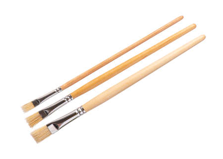 Set of three New wooden artist painting brushes, isolated on white backgroundの写真素材