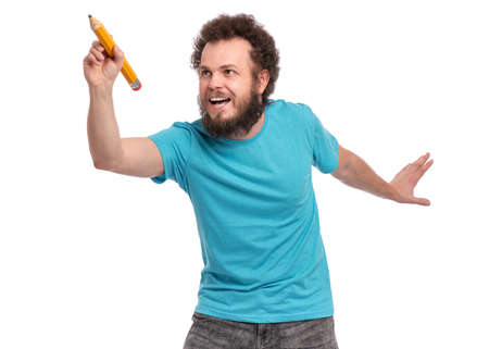 Crazy bearded Man with funny Curly Hair holding Big Pencil, isolated on white background. Happy Guy writing or painting something.の写真素材