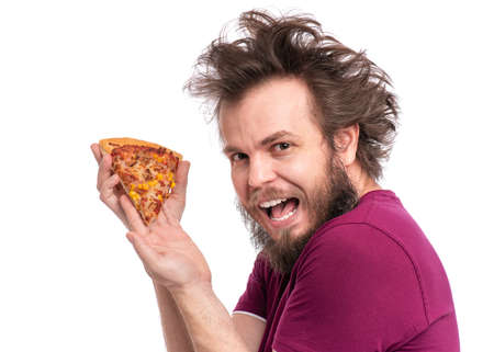 Crazy Bearded Man with funny Haircut. Happy Hungry man Eating Pizza and looking at camera, isolated on white background.の写真素材