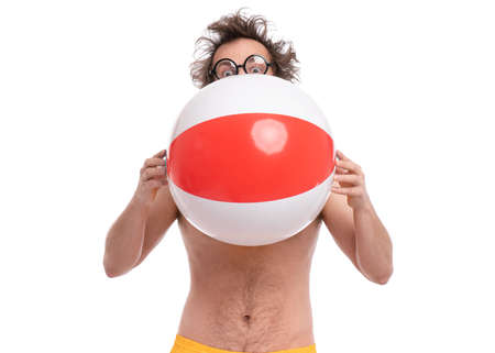 Crazy bearded Man with funny Haircut in eye Glasses, ready for fun at sunny beach. Happy and silly tourist, isolated on white background. Cheerful naked man holding Sea Ball.の写真素材