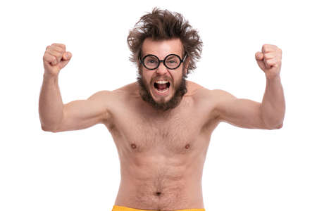Happy winner. Crazy bearded Happy Man with funny Haircut in eye Glasses celebrating his success. Cheerful naked guy screaming and keeping mouth open, isolated on white background.の写真素材