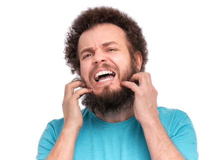 Crazy bearded Man with funny Curly Hair scratching messy beard, isolated on white background. Emotions and signs concept.の写真素材