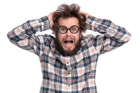Crazy bearded Man with funny Haircut in Eyeglasses, isolated on white background. Surprised or Shocked guy in plaid shirt - screaming and keeping mouth open. Emotions and signs concept.の写真素材