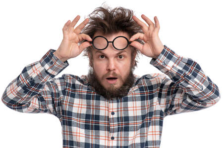 Crazy bearded Man with funny Haircut in Eyeglasses, isolated on white background. Surprised or Shocked guy in plaid shirt, keeping mouth open. Emotions and signs concept.の写真素材