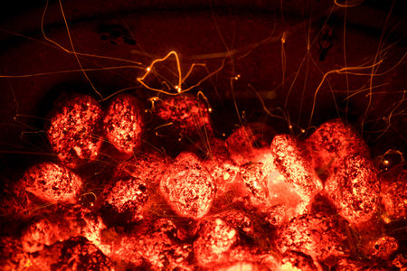 Flame and Fire Sparks at Night. BBQ Grill Pit With Glowing And Flaming Hot Charcoal Briquettes. Cooking Barbecue outdoor.の写真素材