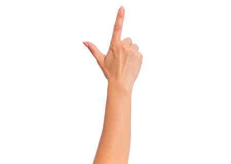Female hand doing gun gesture getting ready to shoot, isolated on white background. Beautiful hand of woman with copy space.の写真素材