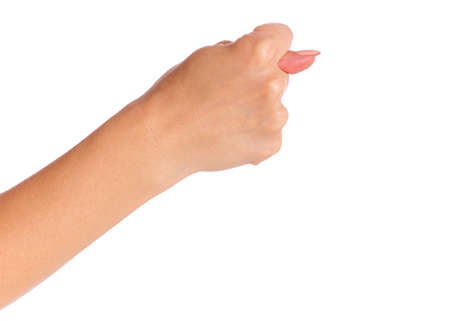 Female hand shows fig gesture, isolated on white background. Beautiful hand of woman with copy space.の写真素材