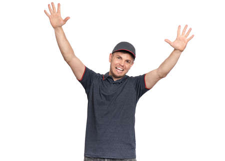 Happy man in cap raised up arms at you. Friendly and sincere male show warm welcome pulling hands, isolated on white background. Smiling man with outstretched hands to embrace someone.の写真素材