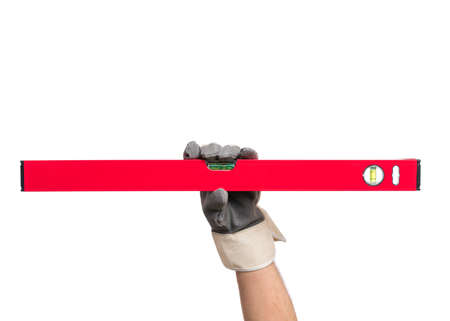 Male Hand wearing Working Glove with red bubble level tool. Human Hand holding building and engineering measure equipment, Isolated on White Background.の写真素材