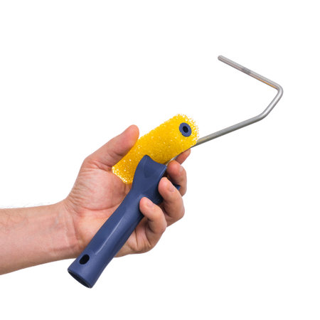 Close up view of Worker Man Hand with Paint Roller Brush. Male Hand with Tools. Human hand holding...