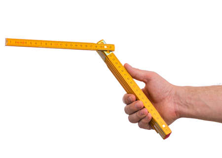 Male Hand with yellow wooden meter. Human Hand holding tool, Isolated on White Background.の写真素材