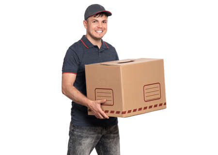 Portrait of Delivery man in cap holding cardboard box. Handsome man, looking on camera. Courier isolated on white background.の写真素材