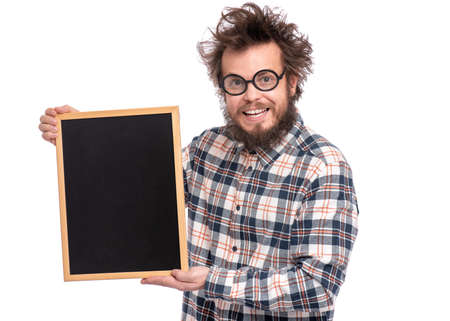 Crazy funny bearded man with tousled hair, scientist or professor in glasses holding teacher blackboard, isolated on white background.の写真素材
