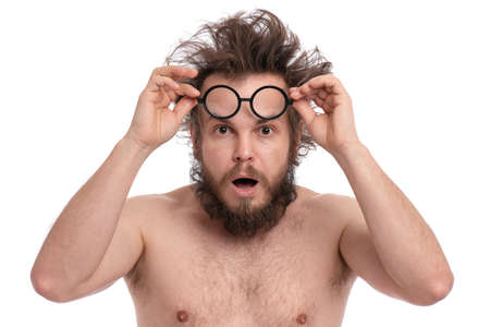 Crazy bearded Scared or Surprised Man with funny Haircut in Eyeglasses, looks worried. Naked guy afraid and shocked, isolated on white background.の写真素材