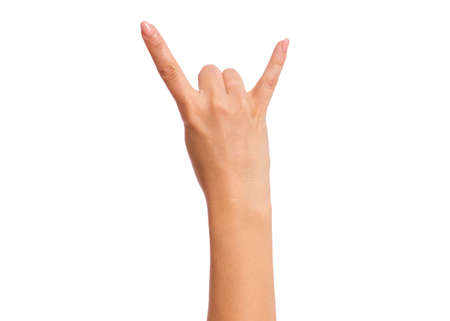 Female hand showing heavy metal Rock gesture, isolated on white background. Beautiful hand of woman with copy space. Hand pointing two fingers.の写真素材